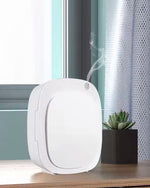Συσκευή αρωματισμού Aroma Smart ByVelcheva σε ράφι δίπλα σε φυτό